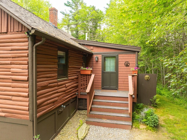 260 Coombs Rd, Brunswick, ME 04011 - view of exterior entry featuring a chimney and roof with shingles