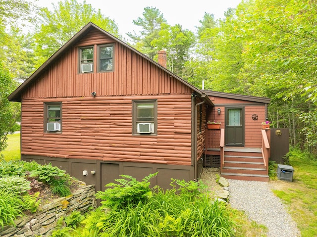 260 Coombs Rd, Brunswick, ME 04011 - view of front of house with a chimney, cooling unit, and board and batten siding