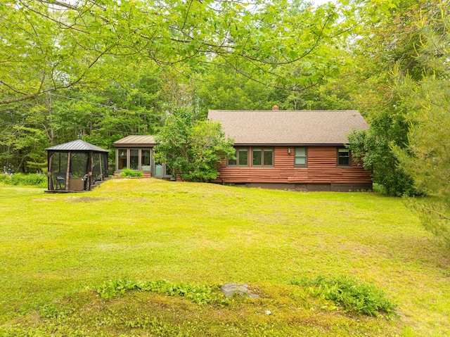 260 Coombs Rd, Brunswick, ME 04011 - view of front of home with a gazebo, a front yard, roof with shingles, a chimney, and log exterior