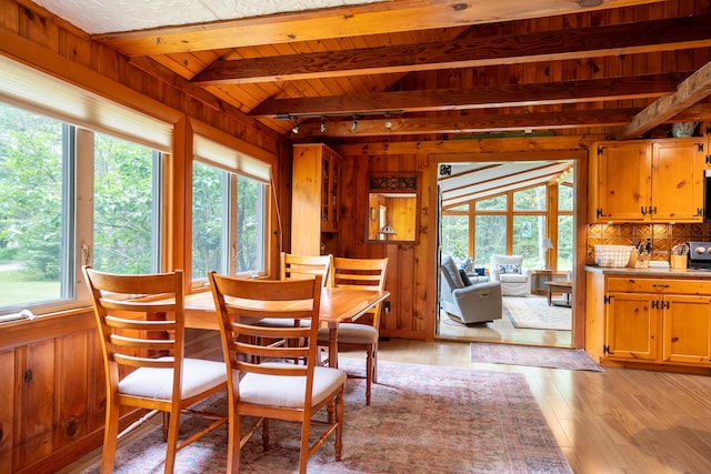 260 Coombs Rd, Brunswick, ME 04011 - dining room with healthy amount of natural light, wood walls, light wood-style flooring, and a wooden ceiling with exposed beams