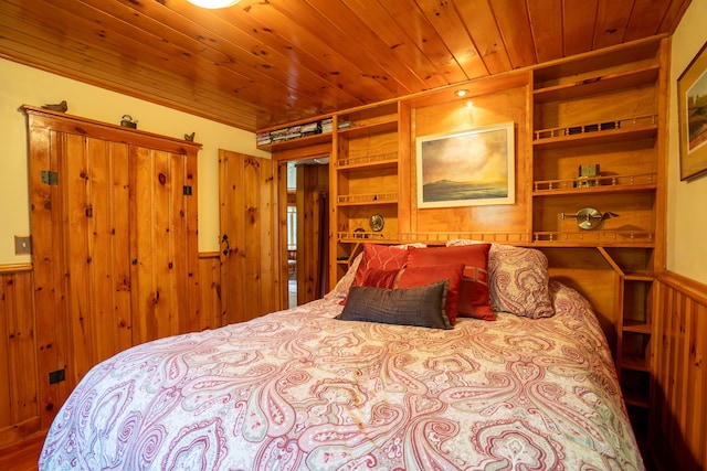 260 Coombs Rd, Brunswick, ME 04011 - bedroom with a wainscoted wall, wood walls, and wood finished floors