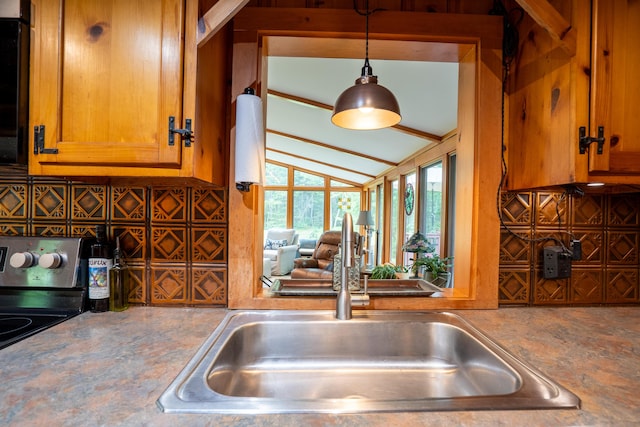 260 Coombs Rd, Brunswick, ME 04011 - kitchen with range, lofted ceiling, pendant lighting, and brown cabinets