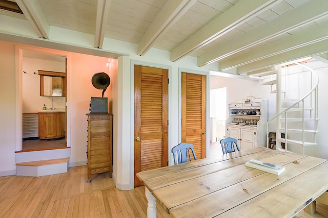 265 Greenacre Rd, Lincolnville, ME 04849 - dining room featuring light wood finished floors, beamed ceiling, and stairs