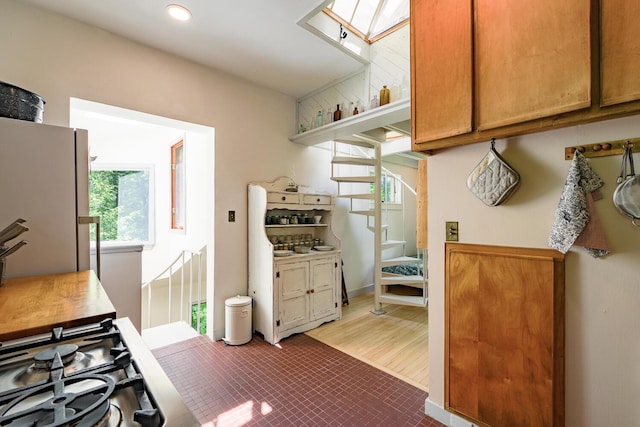 265 Greenacre Rd, Lincolnville, ME 04849 - kitchen featuring freestanding refrigerator, recessed lighting, brown cabinets, and a skylight