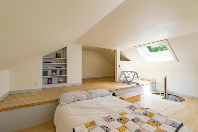 265 Greenacre Rd, Lincolnville, ME 04849 - bedroom featuring a skylight, wood finished floors, and lofted ceiling