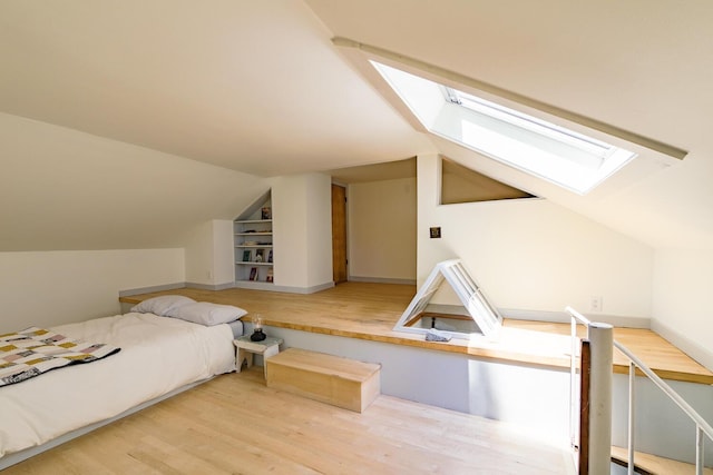 265 Greenacre Rd, Lincolnville, ME 04849 - bedroom with a skylight, vaulted ceiling, and wood finished floors