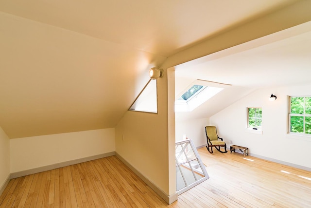 265 Greenacre Rd, Lincolnville, ME 04849 - additional living space with a skylight, light wood finished floors, and vaulted ceiling