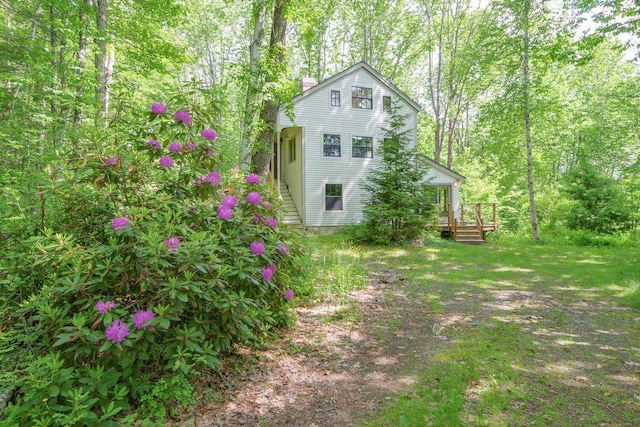 265 Greenacre Rd, Lincolnville, ME 04849 - view of home's exterior with a chimney and a wooden deck