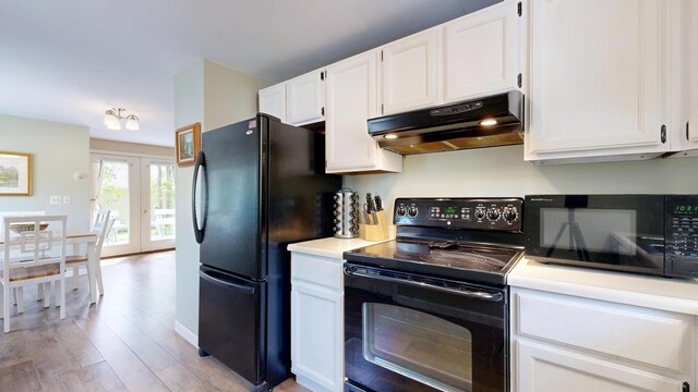 15 Cattail Ln, Monmouth, ME 04259 - kitchen with black appliances, under cabinet range hood, white cabinets, light wood finished floors, and light countertops