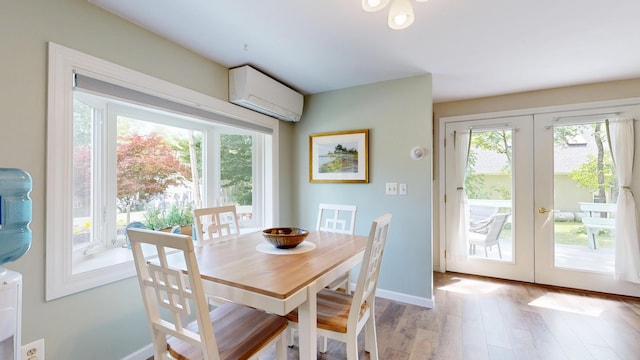 15 Cattail Ln, Monmouth, ME 04259 - dining room featuring an AC wall unit, french doors, plenty of natural light, and light wood-type flooring