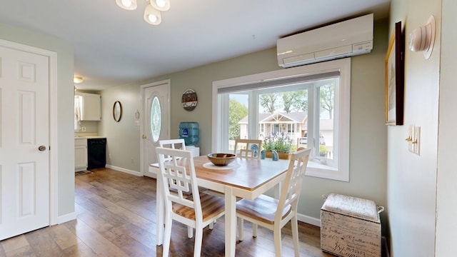 15 Cattail Ln, Monmouth, ME 04259 - dining room with a wall mounted air conditioner and light wood finished floors