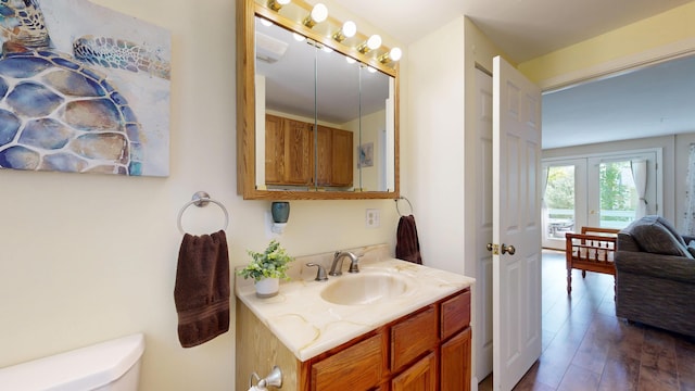 15 Cattail Ln, Monmouth, ME 04259 - bathroom with vanity, french doors, and wood finished floors