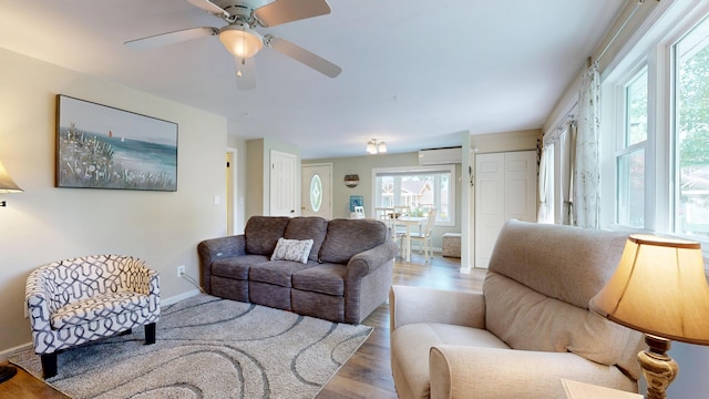 15 Cattail Ln, Monmouth, ME 04259 - living room featuring an AC wall unit, wood finished floors, and a ceiling fan