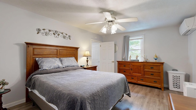 15 Cattail Ln, Monmouth, ME 04259 - bedroom featuring an AC wall unit, light wood finished floors, and ceiling fan