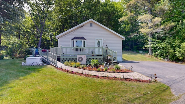 15 Cattail Ln, Monmouth, ME 04259 - view of front of house featuring a front yard, a deck, and view of wooded area