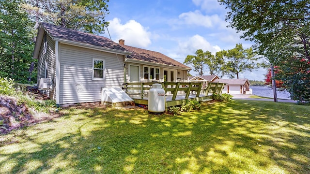15 Cattail Ln, Monmouth, ME 04259 - back of property featuring a lawn, a chimney, and a wooden deck