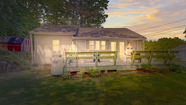 15 Cattail Ln, Monmouth, ME 04259 - back of house with a lawn, a storage unit, a deck, and roof with shingles