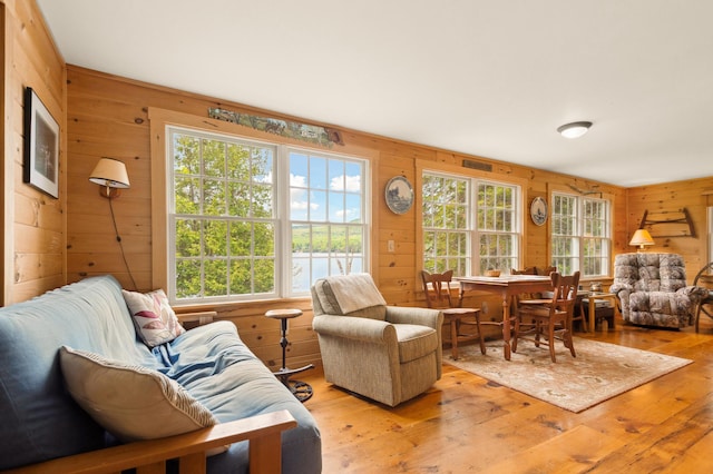 100 Bear Path, Rangeley, ME 04970 - living room featuring wood walls, hardwood / wood-style flooring, and plenty of natural light