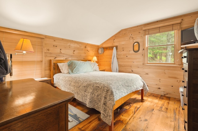 100 Bear Path, Rangeley, ME 04970 - bedroom featuring lofted ceiling, wood walls, and wood-type flooring