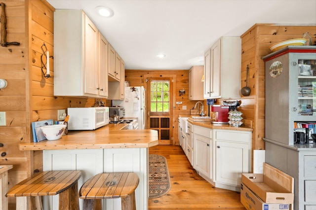 100 Bear Path, Rangeley, ME 04970 - kitchen featuring white appliances, wooden counters, light wood finished floors, recessed lighting, and a peninsula