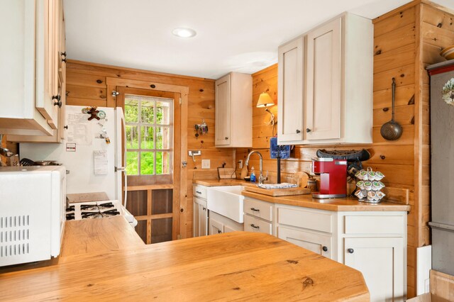 100 Bear Path, Rangeley, ME 04970 - kitchen featuring butcher block countertops, white appliances, and white cabinetry