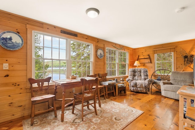 100 Bear Path, Rangeley, ME 04970 - dining space featuring wooden walls, wood-type flooring, and a water view