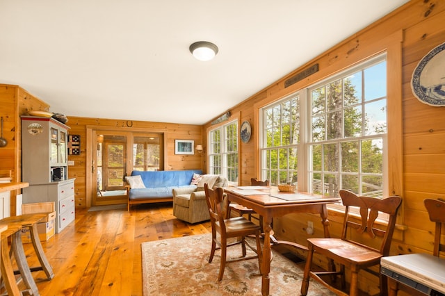 100 Bear Path, Rangeley, ME 04970 - dining room featuring light wood-type flooring and wooden walls
