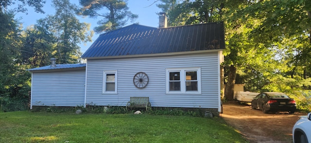48 Gary St, Paris, ME 04281 - view of side of home with a metal roof, a lawn, and a chimney
