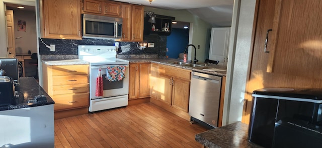 48 Gary St, Paris, ME 04281 - kitchen featuring appliances with stainless steel finishes, tasteful backsplash, dark countertops, and light wood-type flooring