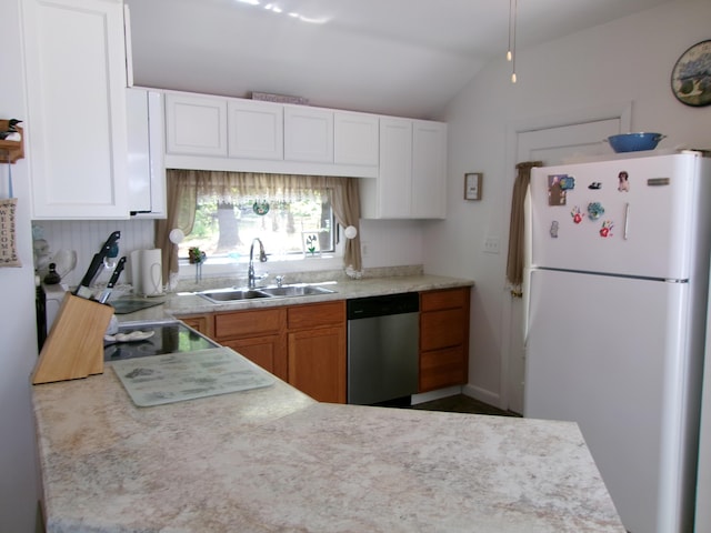 24 Paradise Dr, Monmouth, ME 04259 - kitchen featuring freestanding refrigerator, stainless steel dishwasher, light countertops, vaulted ceiling, and white cabinetry