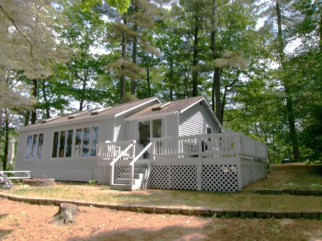 24 Paradise Dr, Monmouth, ME 04259 - back of house featuring a deck, stairway, and view of wooded area
