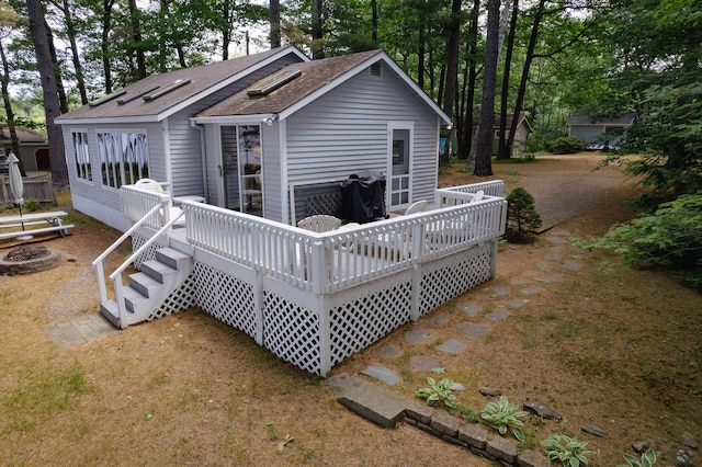 24 Paradise Dr, Monmouth, ME 04259 - back of house featuring a shingled roof, a deck, an outdoor fire pit, and view of wooded area