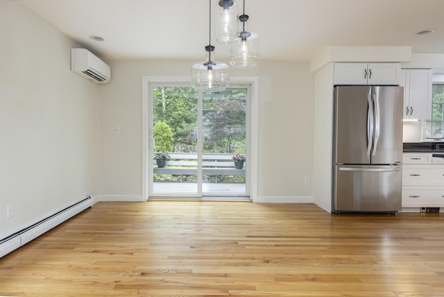 3 Cape Woods Dr Unit 3, Cape Elizabeth, ME 04107 - unfurnished dining area with a wall unit AC, plenty of natural light, and light wood-type flooring