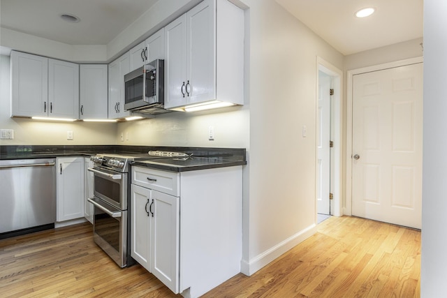 3 Cape Woods Dr Unit 3, Cape Elizabeth, ME 04107 - kitchen featuring appliances with stainless steel finishes, dark countertops, light wood-style flooring, recessed lighting, and white cabinetry