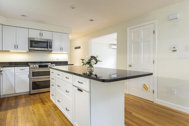3 Cape Woods Dr Unit 3, Cape Elizabeth, ME 04107 - kitchen with stainless steel appliances, light wood-type flooring, dark countertops, and recessed lighting