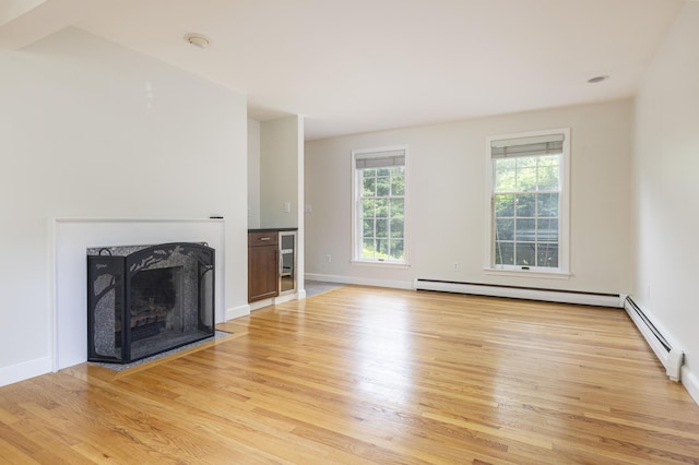 3 Cape Woods Dr Unit 3, Cape Elizabeth, ME 04107 - unfurnished living room with wood finished floors, a baseboard heating unit, and a fireplace with flush hearth
