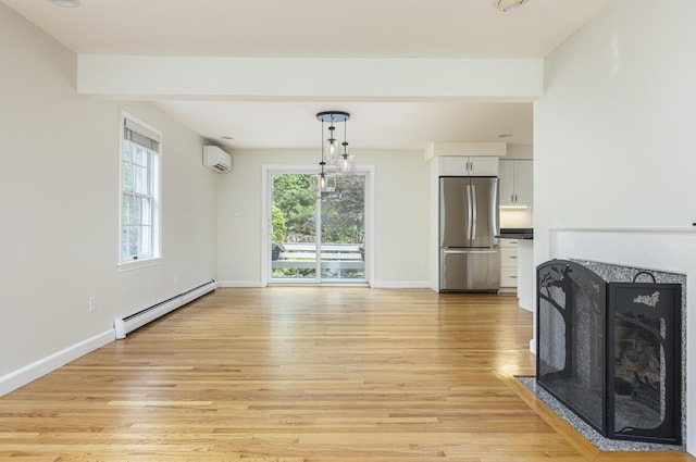 3 Cape Woods Dr Unit 3, Cape Elizabeth, ME 04107 - unfurnished living room with a baseboard radiator, light wood finished floors, a wall mounted AC, and a fireplace with flush hearth