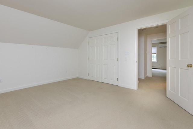 3 Cape Woods Dr Unit 3, Cape Elizabeth, ME 04107 - additional living space with baseboard heating, light colored carpet, vaulted ceiling, and a wall unit AC