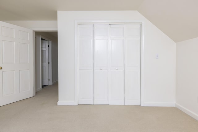 3 Cape Woods Dr Unit 3, Cape Elizabeth, ME 04107 - unfurnished bedroom featuring light carpet, vaulted ceiling, and a closet