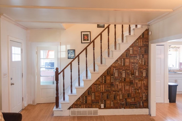 4 E St, Sanford, ME 04073 - entrance foyer featuring wood finished floors, stairway, and crown molding