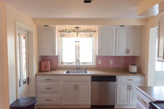 4 E St, Sanford, ME 04073 - kitchen featuring stainless steel dishwasher, white cabinets, decorative backsplash, and light countertops