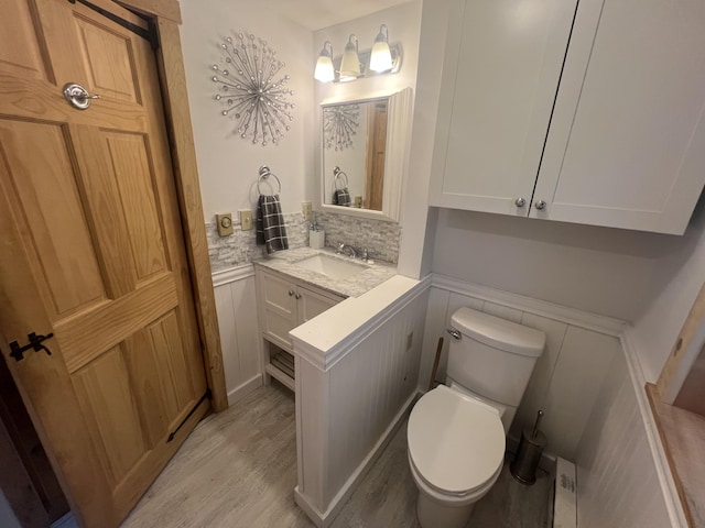 87 Perch Pt, Shapleigh, ME 04076 - bathroom featuring vanity, wood finished floors, and a wainscoted wall