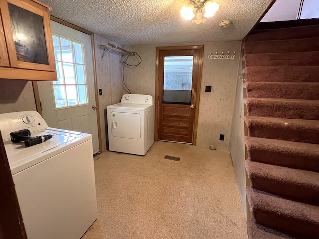 257 N Ave, Skowhegan, ME 04976 - laundry area with washing machine and clothes dryer, a textured ceiling, cabinet space, and light colored carpet