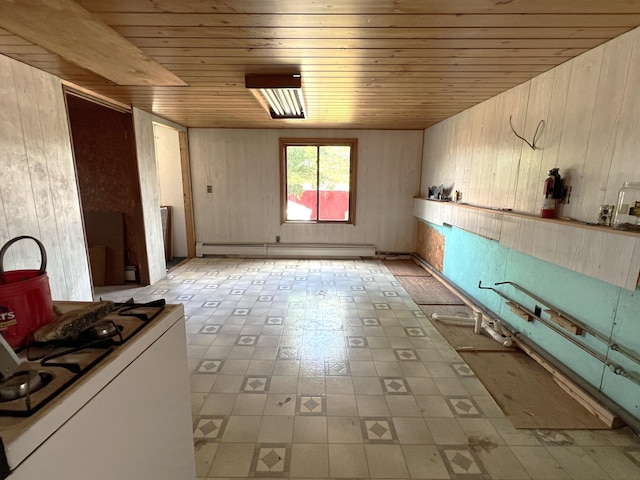 257 N Ave, Skowhegan, ME 04976 - kitchen featuring wood ceiling, a baseboard heating unit, wooden walls, light floors, and white range with gas stovetop