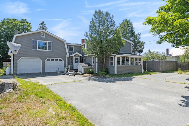 257 N Ave, Skowhegan, ME 04976 - view of front of property with a chimney, an attached garage, asphalt driveway, and a gambrel roof