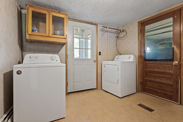 257 N Ave, Skowhegan, ME 04976 - laundry area with cabinet space, a textured ceiling, washer and clothes dryer, and light colored carpet