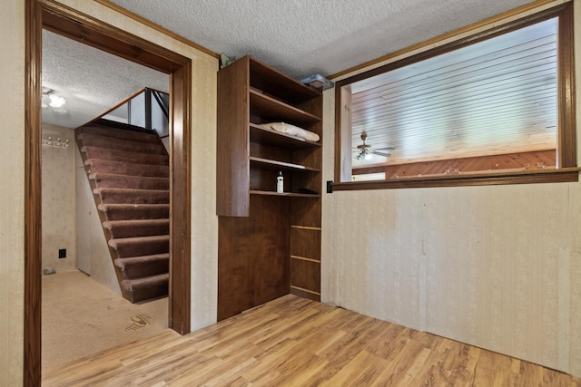 257 N Ave, Skowhegan, ME 04976 - unfurnished room featuring a textured ceiling, wood finished floors, ceiling fan, and stairs