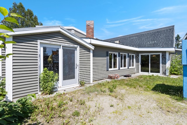 257 N Ave, Skowhegan, ME 04976 - back of house featuring a chimney and roof with shingles