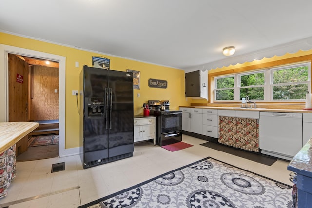 1548 Main St, Readfield, ME 04355 - kitchen featuring black appliances, white cabinets, and ornamental molding