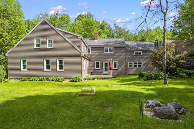 1548 Main St, Readfield, ME 04355 - back of property with a chimney, a yard, a deck, and a shingled roof